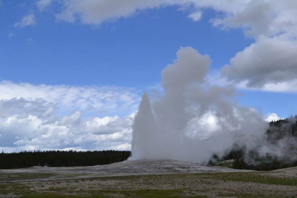 Watch Old Faithful erupting as part of a 3 day Yellowstone itinerary from the west entrance