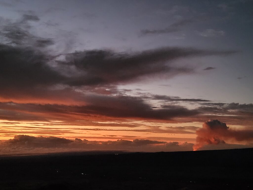 Kilauea Volcano erupting in the background of Mauna Kea